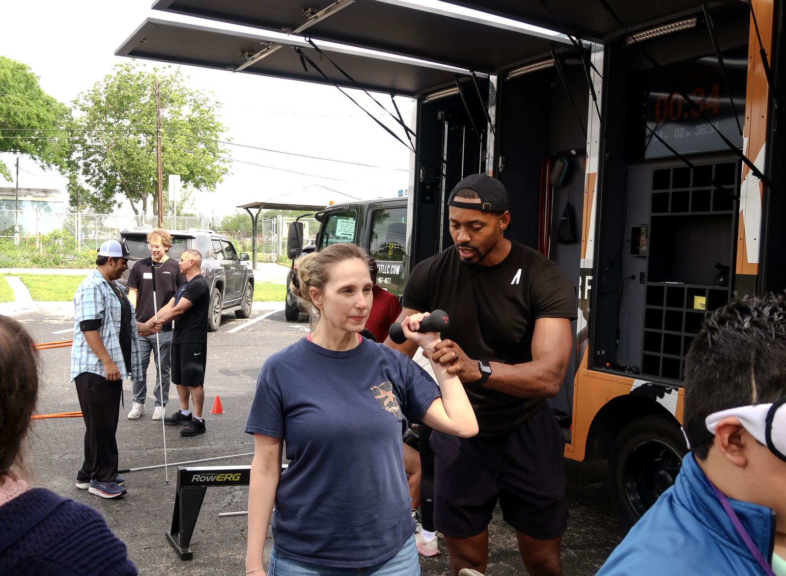 A participant listening to a coach's guidance at the mobile gym